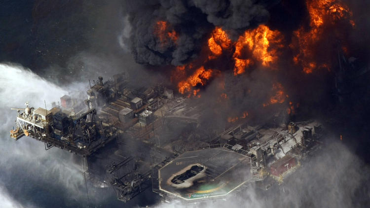 BP's Deepwater Horizon oil platform burns in April 2010, fouling the Gulf Coast: Is it responsible for a massive die-off of dolphins? (Gerald Herbert / Associated Press)